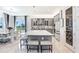 Modern kitchen with an island, gray cabinets, stylish backsplash, and contemporary pendant lighting at 32423 Rosewood Meadow Ln, Wesley Chapel, FL 33543