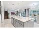 Open-concept kitchen with white countertops, an island, and views into the adjacent living and dining areas at 32423 Rosewood Meadow Ln, Wesley Chapel, FL 33543
