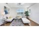 Bright living room with hardwood floors, comfortable seating, and large windows for natural light at 32423 Rosewood Meadow Ln, Wesley Chapel, FL 33543