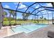 A luxurious pool and spa combination is set within a screened enclosure at 32423 Rosewood Meadow Ln, Wesley Chapel, FL 33543