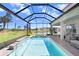View of screened pool featuring a spa with waterfall, and comfortable outdoor seating at 32423 Rosewood Meadow Ln, Wesley Chapel, FL 33543