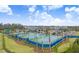 Tennis courts with blue and green surfaces with shelters provide ample space for play and relaxation at 32423 Rosewood Meadow Ln, Wesley Chapel, FL 33543
