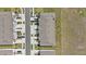 Aerial view of townhomes with designated parking, set amidst green spaces and manicured landscaping at 33064 Tulip Petal Ln, Wesley Chapel, FL 33545