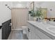 Stylish bathroom with a double sink vanity, shower with curtain, and wainscoting at 33064 Tulip Petal Ln, Wesley Chapel, FL 33545