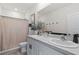 Modern bathroom with double sinks, neutral décor, shower curtain and vanity at 33064 Tulip Petal Ln, Wesley Chapel, FL 33545