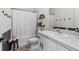 Bathroom with a white shower curtain, vanity, and dark accent wall at 33064 Tulip Petal Ln, Wesley Chapel, FL 33545