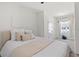 Light-filled bedroom featuring a cozy bed, bright window, and fresh, modern design at 33064 Tulip Petal Ln, Wesley Chapel, FL 33545