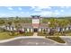 Exterior shot of the community clubhouse showcasing architectural detail and lush landscaping at 33064 Tulip Petal Ln, Wesley Chapel, FL 33545
