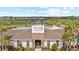 Community clubhouse and pool featuring comfortable lounge areas and tropical landscaping at 33064 Tulip Petal Ln, Wesley Chapel, FL 33545