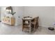Dining area featuring a wooden table with seating for four, accented by a cabinet at 33064 Tulip Petal Ln, Wesley Chapel, FL 33545