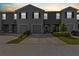 Row of well-maintained townhomes featuring attached garages and neat landscaping at 33064 Tulip Petal Ln, Wesley Chapel, FL 33545