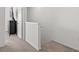 Hallway leading to a bedroom with a chest of drawers and TV at 33064 Tulip Petal Ln, Wesley Chapel, FL 33545