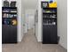 Hallway featuring dark wood shelving units with decor items at 33064 Tulip Petal Ln, Wesley Chapel, FL 33545