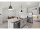 Modern kitchen boasts a large island, stainless steel refrigerator, and sleek pendant lighting at 33064 Tulip Petal Ln, Wesley Chapel, FL 33545