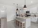 Modern kitchen featuring white cabinets, granite counters, stainless steel appliances, and a center island at 33064 Tulip Petal Ln, Wesley Chapel, FL 33545