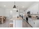 Bright kitchen featuring white cabinets, stainless steel appliances, and a center island with pendant lighting at 33064 Tulip Petal Ln, Wesley Chapel, FL 33545