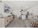 Open-concept living space featuring a kitchen, dining area, comfortable sofas, and modern decor at 33064 Tulip Petal Ln, Wesley Chapel, FL 33545