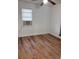This bedroom is equipped with a ceiling fan and wood-look floors at 38030 Howard Ave, Dade City, FL 33525