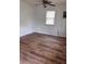 This bedroom is equipped with a ceiling fan and wood-look floors at 38030 Howard Ave, Dade City, FL 33525