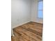 This is a cozy bedroom with wood-look floors and a window at 38030 Howard Ave, Dade City, FL 33525