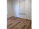 This is a cozy bedroom with wood-look floors and a window at 38030 Howard Ave, Dade City, FL 33525