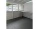 This enclosed porch is well lit and can be used for storage or recreation at 38030 Howard Ave, Dade City, FL 33525