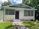 An exterior shot of the front of the house showing the door and windows at 38030 Howard Ave, Dade City, FL 33525