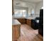 A spacious kitchen featuring modern black appliances and wood flooring at 38030 Howard Ave, Dade City, FL 33525