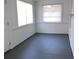 Well lit living room with painted wood floors and large windows at 38030 Howard Ave, Dade City, FL 33525