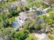 Aerial view of a home with a screened pool, lush backyard, and a brick driveway at 405 Apache Trl, Brandon, FL 33511