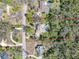 Aerial view of the property with a sparkling pool, mature trees, and the house outlined in red at 405 Apache Trl, Brandon, FL 33511
