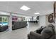 Finished basement with a bar, lounge area, fireplace, and sliding doors to the backyard at 405 Apache Trl, Brandon, FL 33511