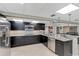 Basement kitchen with stainless steel appliances, granite counters, and bar seating at 405 Apache Trl, Brandon, FL 33511