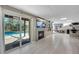 Walkout basement featuring sliding doors to the pool, fireplace, and bar with seating at 405 Apache Trl, Brandon, FL 33511