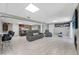Spacious finished basement with a fireplace, bar, and multiple seating areas at 405 Apache Trl, Brandon, FL 33511