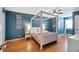 Charming bedroom with blue walls, hardwood floors, a four poster bed, and stylish decorations at 405 Apache Trl, Brandon, FL 33511