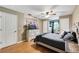 Comfortable bedroom featuring hardwood floors, a ceiling fan, and neutral decor for a serene and inviting atmosphere at 405 Apache Trl, Brandon, FL 33511