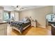 Cozy bedroom with hardwood floors, a comfortable bed, and a vanity, perfect for relaxing and unwinding at 405 Apache Trl, Brandon, FL 33511