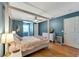This bedroom features a four-poster bed, wood floors, and blue painted walls at 405 Apache Trl, Brandon, FL 33511