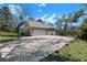 Spacious brick driveway with a basketball hoop leading to the two-car garage at 405 Apache Trl, Brandon, FL 33511