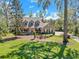 Two-story home with a red front door, nestled within a picturesque landscape at 405 Apache Trl, Brandon, FL 33511