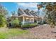 Inviting home featuring a charming front porch, well-kept lawn, and mature landscaping for added curb appeal at 405 Apache Trl, Brandon, FL 33511