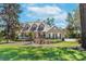 Charming single-Gathering home with a manicured lawn, white porch, and a bright red front door at 405 Apache Trl, Brandon, FL 33511