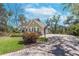 Attractive home with a brick driveway, a well-maintained lawn, and mature trees offering a serene setting at 405 Apache Trl, Brandon, FL 33511