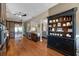 Spacious kitchen with stainless steel refrigerator, hardwood floors, and view of the open floor plan at 405 Apache Trl, Brandon, FL 33511