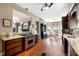 Open kitchen with hardwood floors, island, custom cabinetry, and adjacent dining area at 405 Apache Trl, Brandon, FL 33511