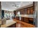 Gourmet kitchen with custom cabinets, marble countertops, stainless steel appliances, and hardwood flooring at 405 Apache Trl, Brandon, FL 33511