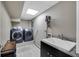 Functional laundry room includes a sink, washer, dryer, and ample counter space for convenient chores at 405 Apache Trl, Brandon, FL 33511