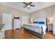 Inviting main bedroom featuring hardwood floors, ceiling fan, and a comfortable bed with nightstands at 405 Apache Trl, Brandon, FL 33511