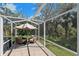 Charming patio seating area with a shaded umbrella, perfect for relaxation and outdoor enjoyment at 405 Apache Trl, Brandon, FL 33511